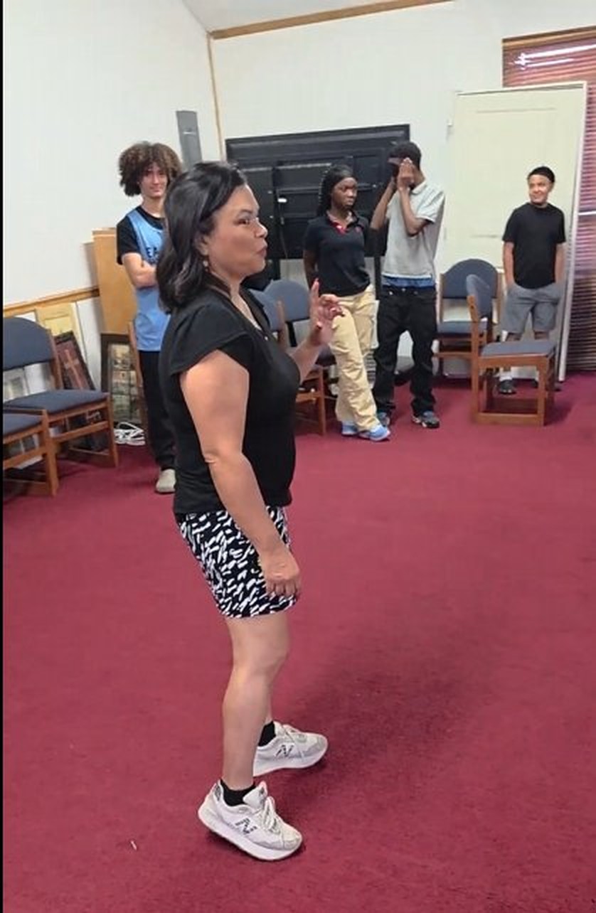 Mrs. Weems leading role-playing activity with students