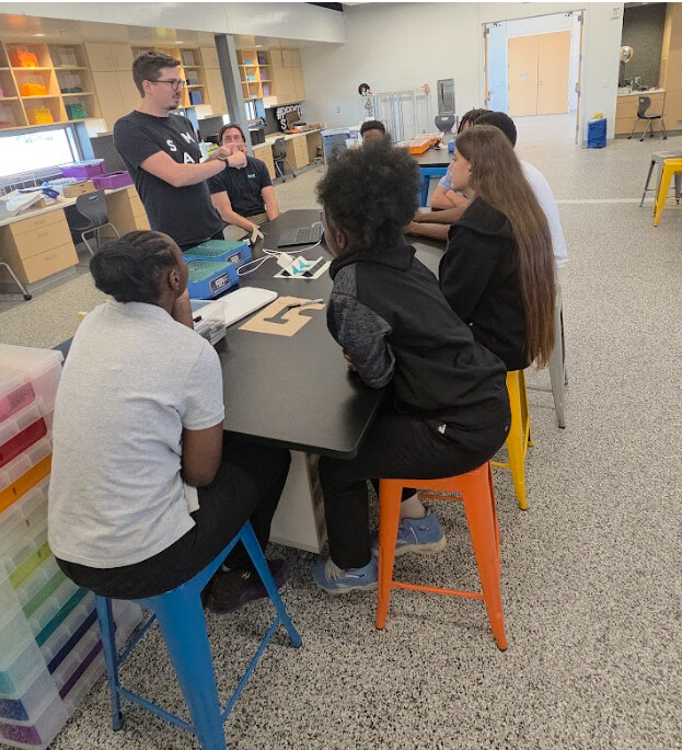 Students gathered around table during makerspace session