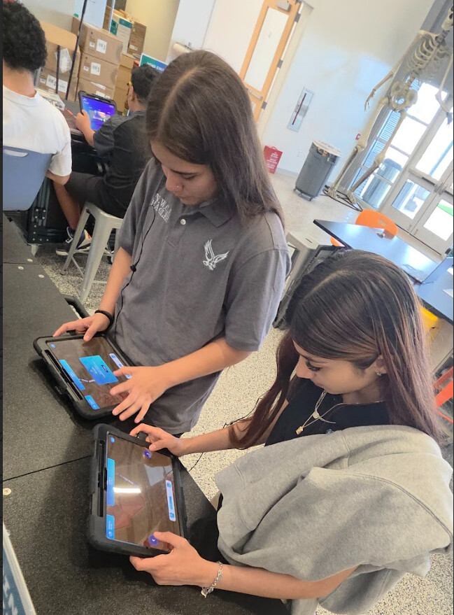 Students coding on tablets during STEM activity