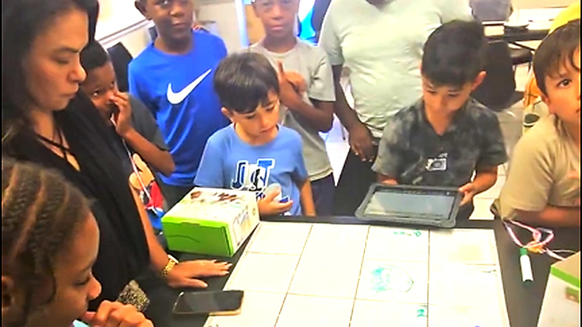 Students collaborating at robotics table